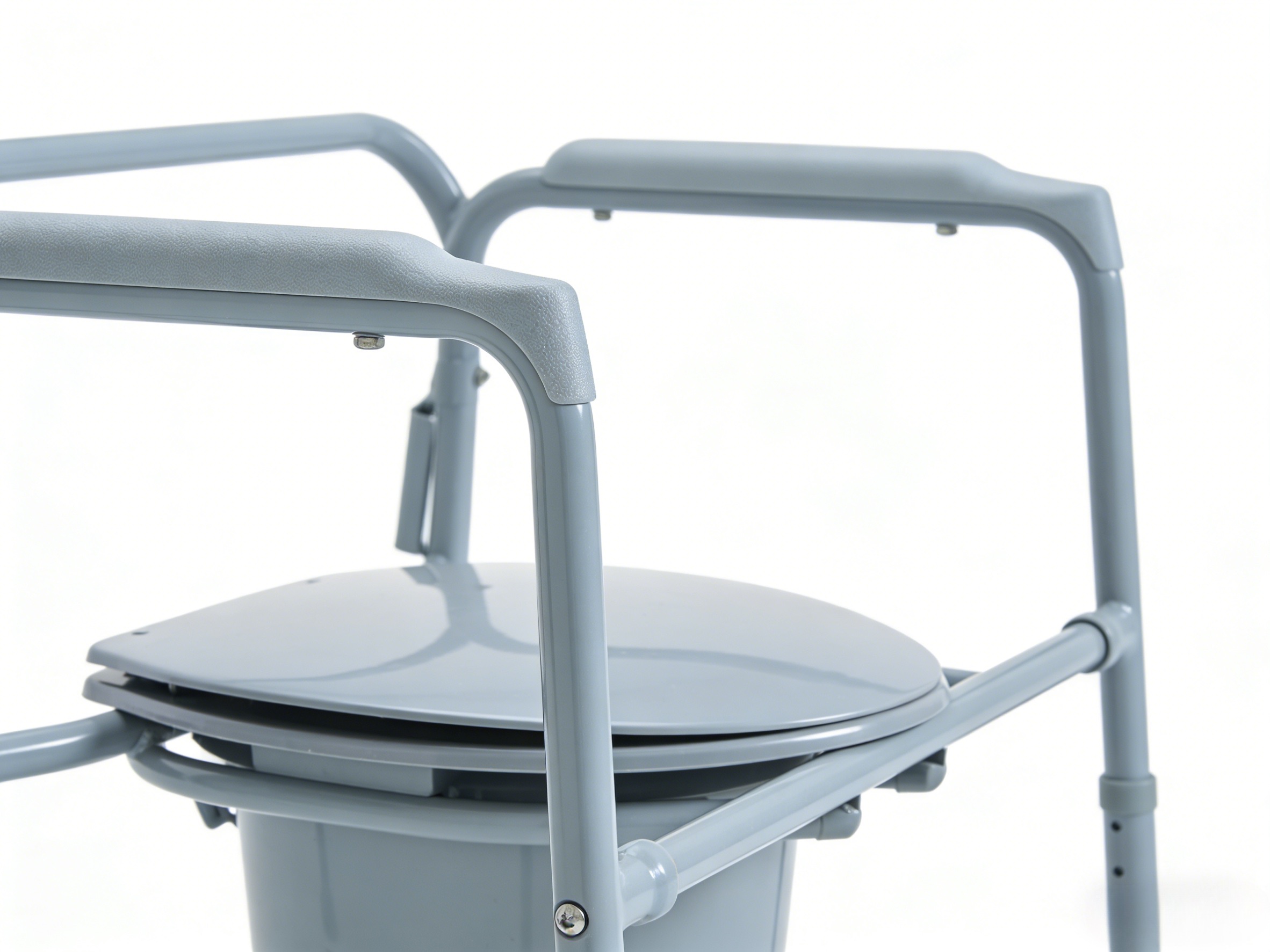 Nahaufnahme des Pr&auml;zisionsschwei&szlig;ens und der hochdichten gepolsterten Armlehnen an einem professionellen bariatrischen Toilettenstuhl.